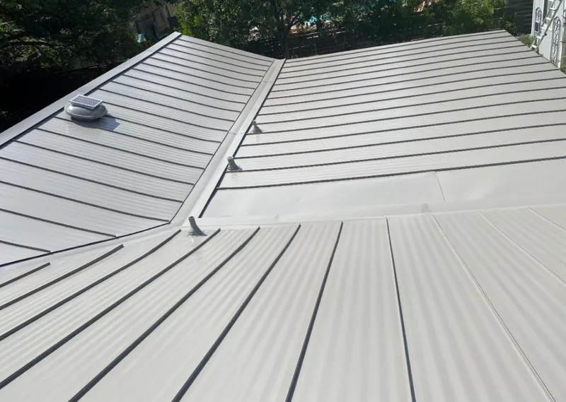 Solar attic fan installed on a metal roof for Roof Ventilation in Laguna Beach